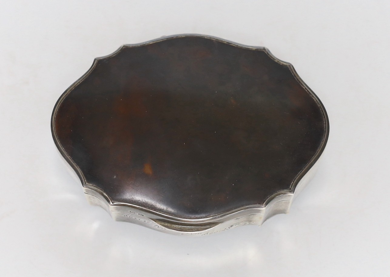 A George V silver and tortoiseshell mounted shaped oval trinket box, Birmingham, 1929, with engraved inscription, 12.6cm.